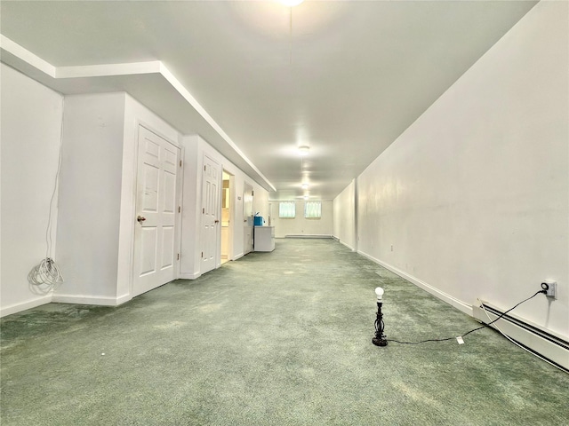 carpeted spare room featuring baseboard heating and baseboards