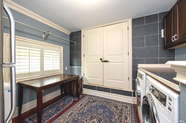 clothes washing area with independent washer and dryer, cabinet space, tile walls, and crown molding