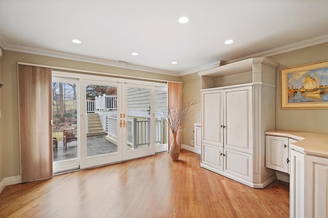 doorway to outside with crown molding, recessed lighting, and light wood-style floors