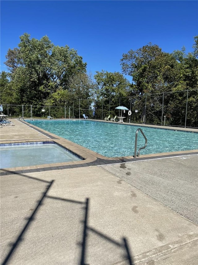 pool featuring fence and a patio