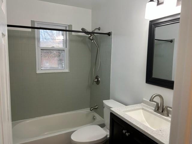 bathroom featuring toilet, bathtub / shower combination, and vanity