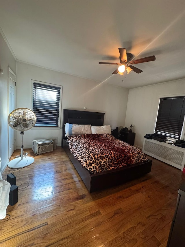 bedroom featuring a ceiling fan and wood finished floors