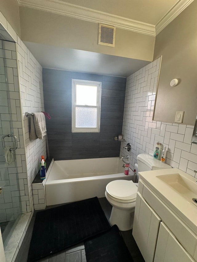 full bathroom featuring visible vents, toilet, ornamental molding, vanity, and tile walls