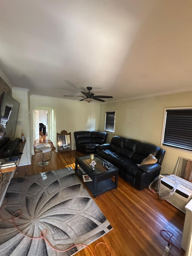 living room with a ceiling fan, crown molding, and wood finished floors