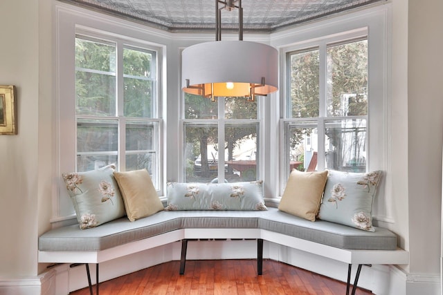 sitting room with hardwood / wood-style floors and an ornate ceiling