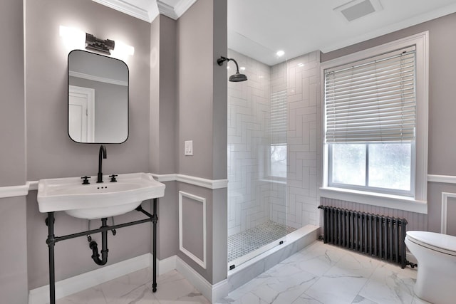 bathroom featuring marble finish floor, a tile shower, radiator heating unit, and toilet