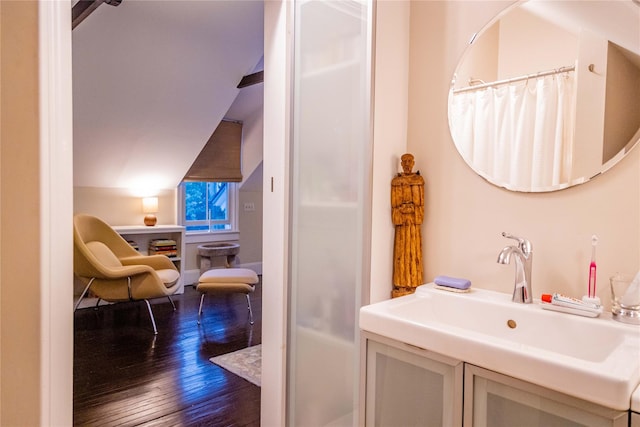 full bathroom featuring lofted ceiling, wood-type flooring, and vanity