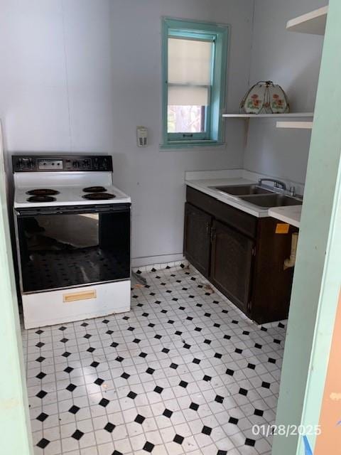 kitchen featuring a sink, electric stove, open shelves, and light countertops