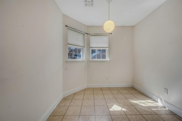 unfurnished room with visible vents, baseboards, and light tile patterned floors