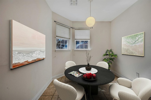 tiled dining space featuring visible vents and baseboards