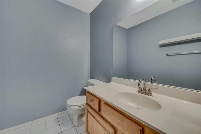 half bath featuring vanity, tile patterned flooring, and toilet