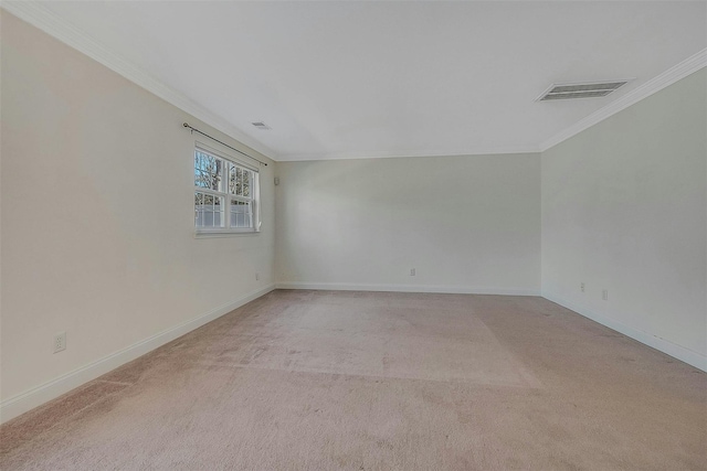 spare room featuring ornamental molding, visible vents, light carpet, and baseboards