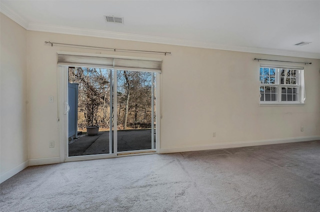 empty room with ornamental molding, baseboards, visible vents, and carpet flooring