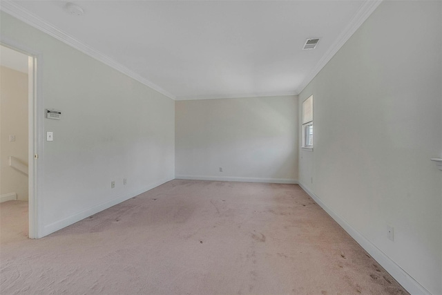 spare room featuring crown molding, baseboards, visible vents, and light colored carpet