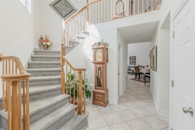 staircase featuring tile patterned flooring and baseboards