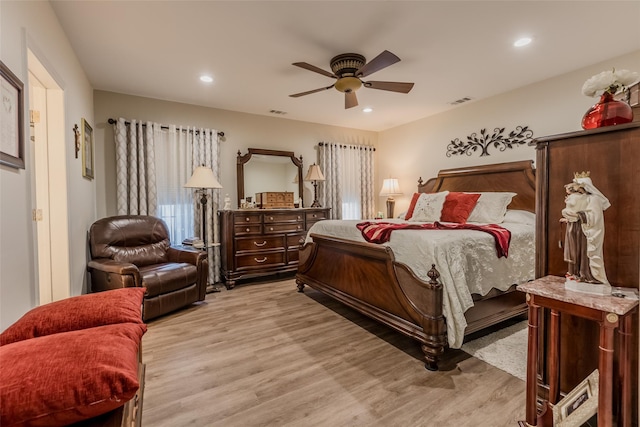 bedroom with a ceiling fan, recessed lighting, visible vents, and light wood-style floors