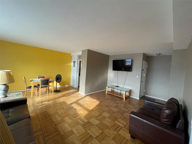 living area featuring baseboards