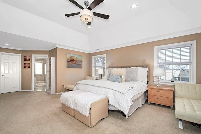 bedroom with connected bathroom, recessed lighting, light colored carpet, baseboards, and crown molding