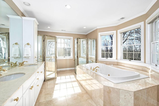 bathroom with a jetted tub, double vanity, ornamental molding, and a sink