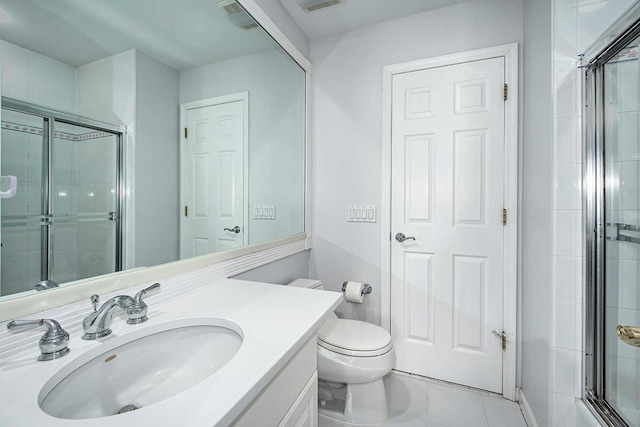 full bathroom with visible vents, toilet, tile patterned floors, a tile shower, and vanity