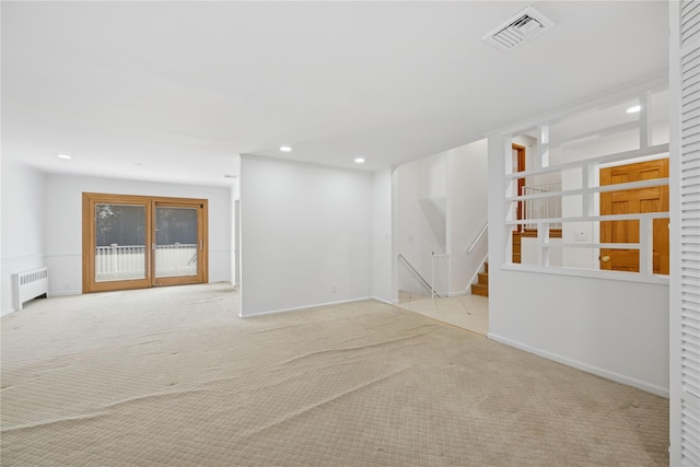 carpeted empty room with recessed lighting, visible vents, baseboards, stairway, and radiator