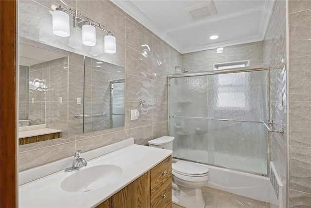 full bath featuring visible vents, vanity, tile walls, and crown molding