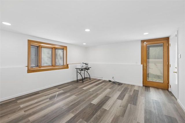 empty room featuring recessed lighting, baseboards, and wood finished floors