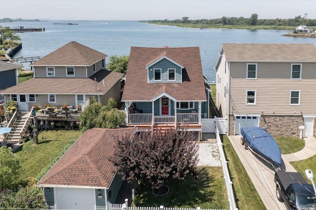 birds eye view of property with a water view and a residential view