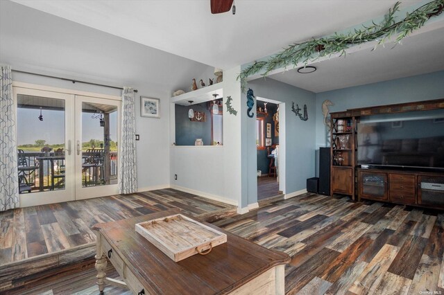 unfurnished living room featuring ceiling fan, baseboards, wood finished floors, and french doors