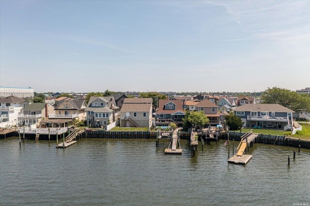 property view of water featuring a dock and a residential view