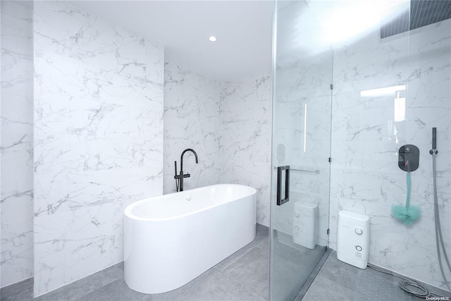 full bathroom featuring a soaking tub, a marble finish shower, tile walls, and recessed lighting