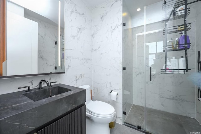 full bath with toilet, a marble finish shower, tile walls, and vanity