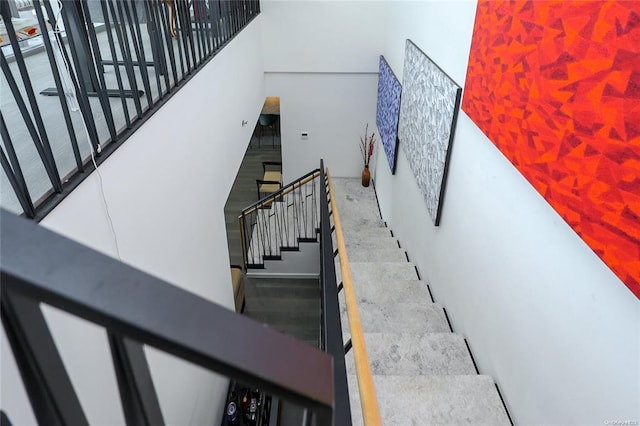 stairway featuring a high ceiling