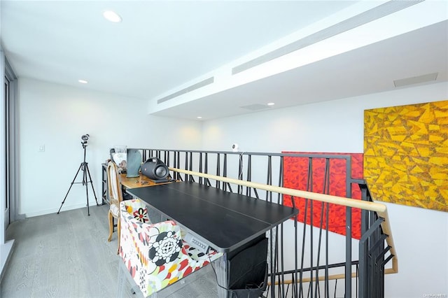 interior space featuring recessed lighting, baseboards, and wood finished floors