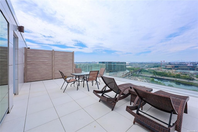 balcony featuring a city view and a water view