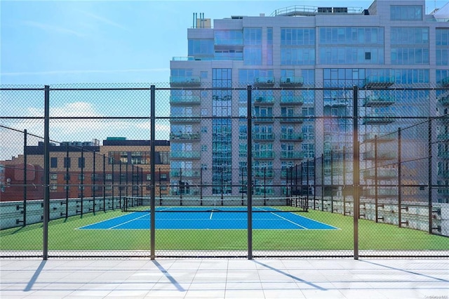 view of tennis court featuring fence