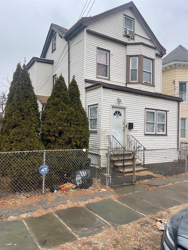 view of front facade with entry steps and a fenced front yard