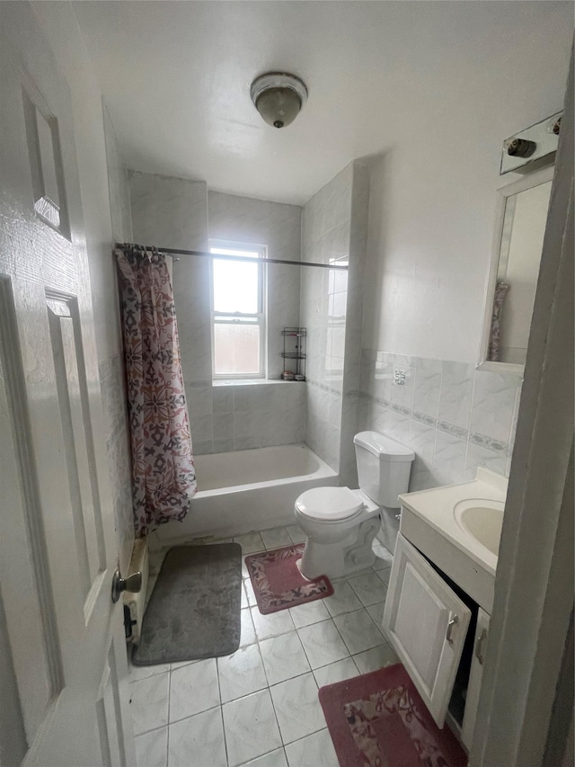 full bath with tile walls, toilet, shower / bath combo, vanity, and tile patterned flooring