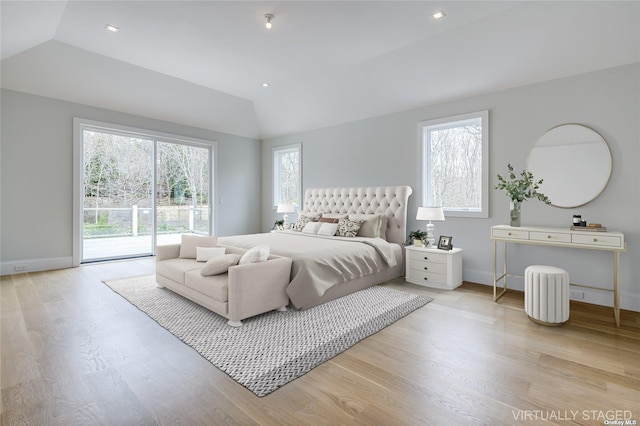 bedroom featuring access to exterior, vaulted ceiling, multiple windows, and light wood finished floors