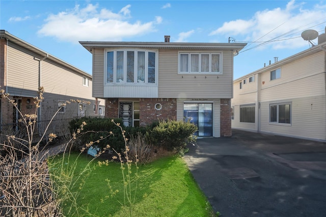 back of house featuring brick siding