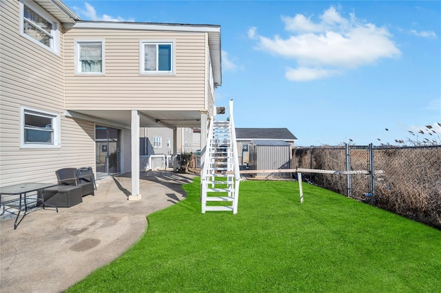 view of yard featuring a patio area, a fenced backyard, and stairway