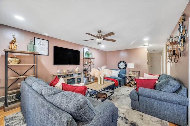 living area with a ceiling fan, wood finished floors, and recessed lighting