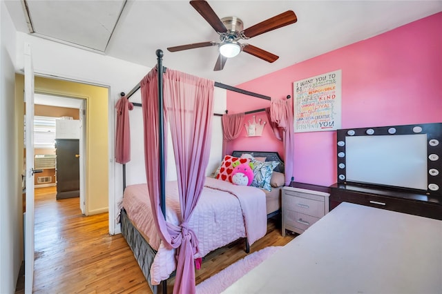 bedroom featuring ceiling fan, wood finished floors, and visible vents