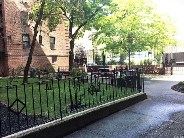 surrounding community featuring a lawn and fence