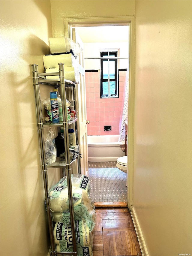 bathroom featuring hardwood / wood-style floors, shower / tub combination, and toilet