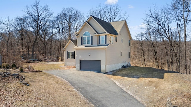 view of home's exterior with aphalt driveway and a garage