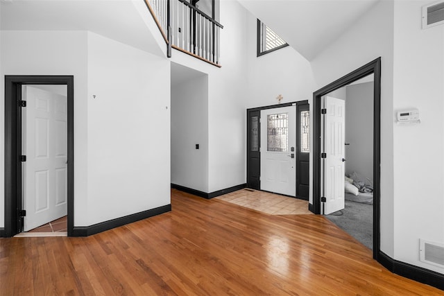 entrance foyer with visible vents, baseboards, and wood finished floors