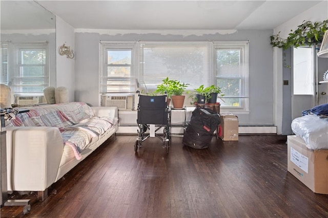 living room with cooling unit, baseboard heating, and hardwood / wood-style flooring