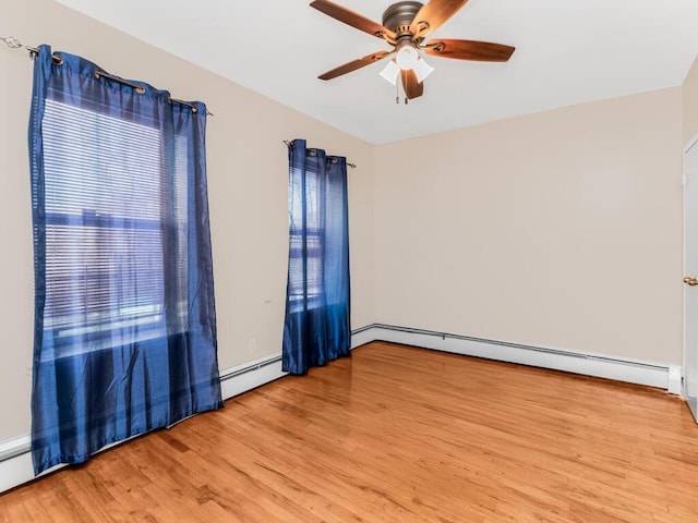 empty room featuring ceiling fan, light wood finished floors, baseboard heating, and lofted ceiling