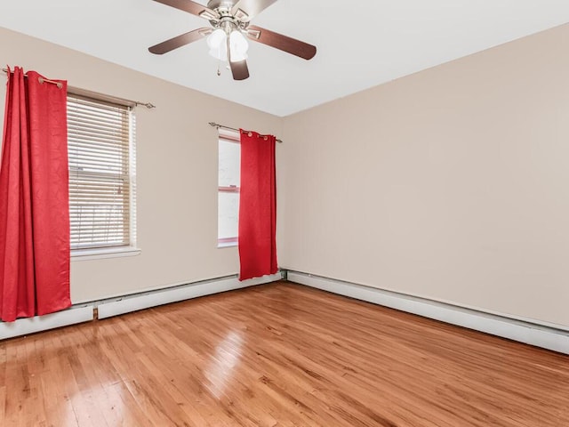 empty room featuring a baseboard radiator, light wood-style flooring, and a ceiling fan